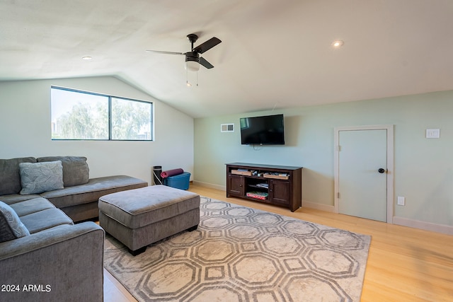 living room with ceiling fan, light wood-type flooring, and lofted ceiling