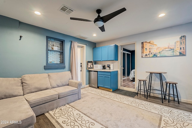 living room featuring ceiling fan and hardwood / wood-style flooring