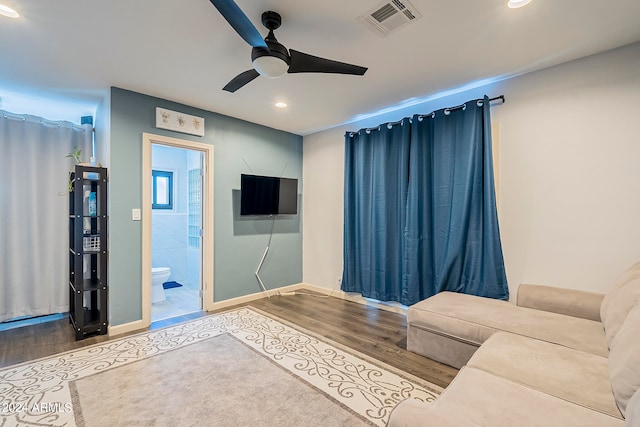 living room featuring ceiling fan and hardwood / wood-style floors