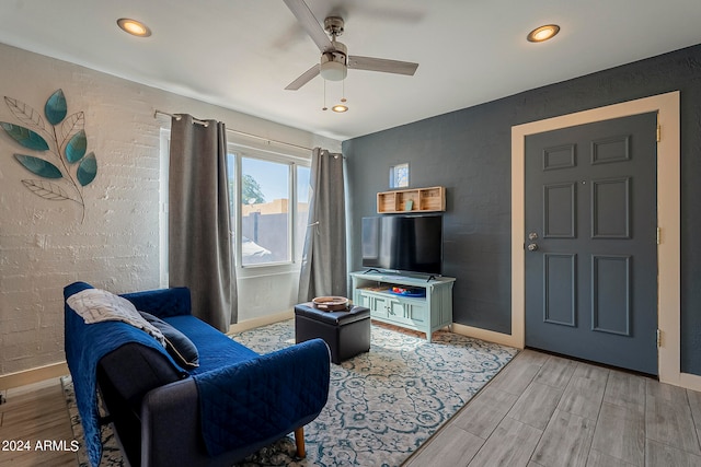 living room featuring light wood-type flooring and ceiling fan