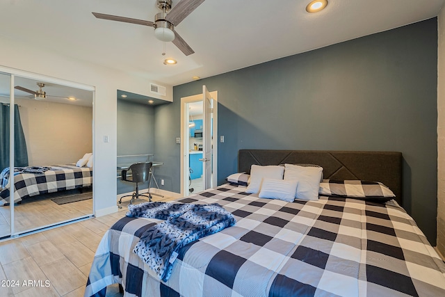 bedroom featuring light hardwood / wood-style flooring, a closet, and ceiling fan