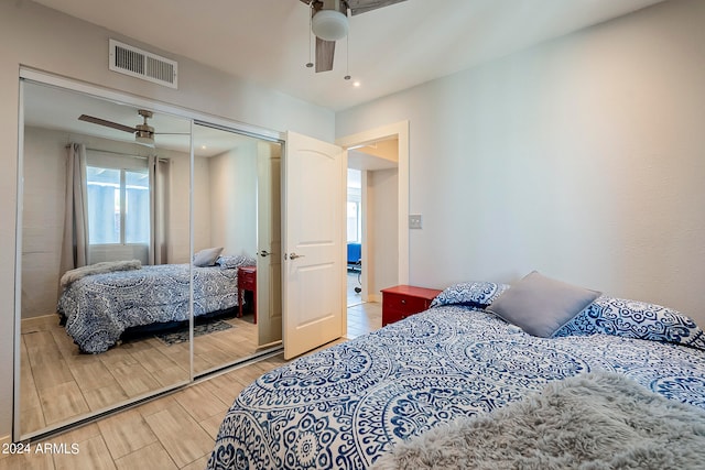 bedroom with ceiling fan, hardwood / wood-style flooring, and a closet