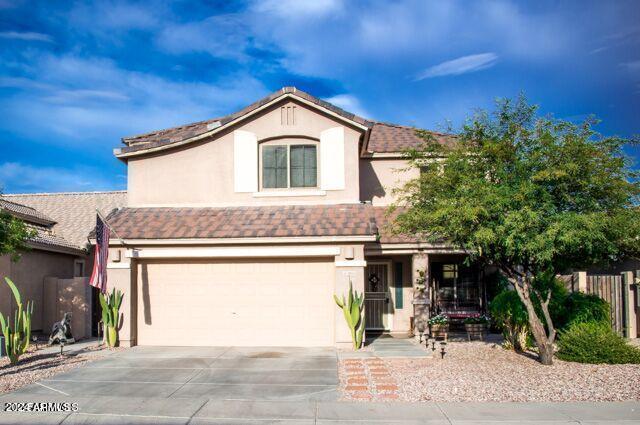 29101 N Yellow Bee Dr, San Tan Valley, AZ 85143 - traditional-style house with an attached garage, concrete driveway, stucco siding, and fence