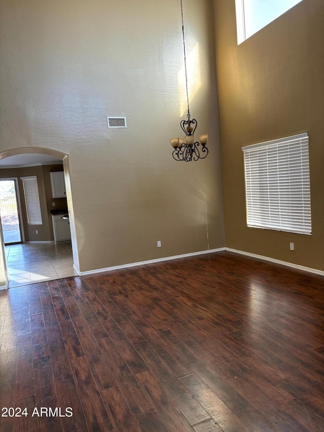 29101 N Yellow Bee Dr, San Tan Valley, AZ 85143 - spare room with arched walkways, visible vents, hardwood / wood-style flooring, and a healthy amount of sunlight