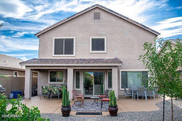 29101 N Yellow Bee Dr, San Tan Valley, AZ 85143 - back of house featuring a patio area, stucco siding, and fence