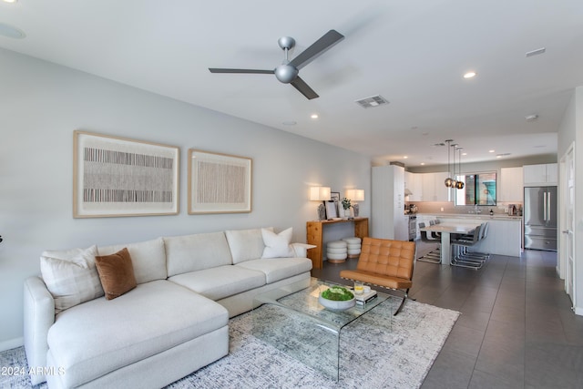 tiled living room featuring ceiling fan