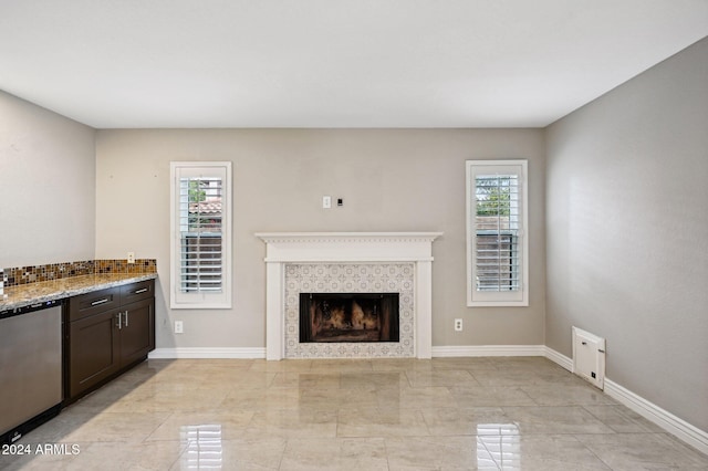 5544 E Paradise Ln, Scottsdale, AZ 85254 - unfurnished living room featuring baseboards and a fireplace