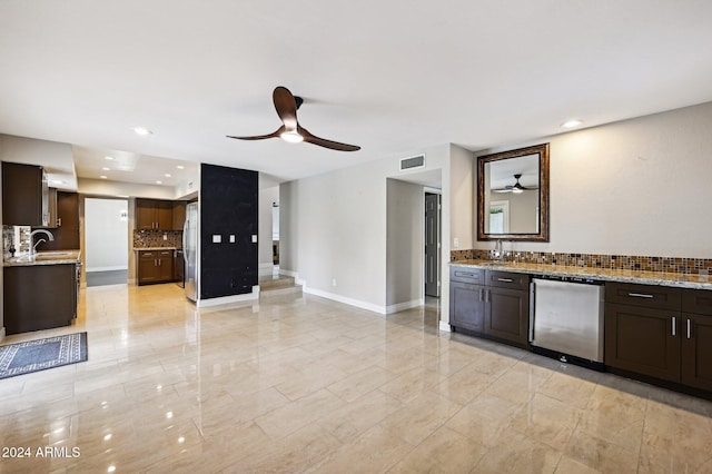 5544 E Paradise Ln, Scottsdale, AZ 85254 - kitchen featuring a ceiling fan, refrigerator, freestanding refrigerator, tasteful backsplash, and dark brown cabinetry