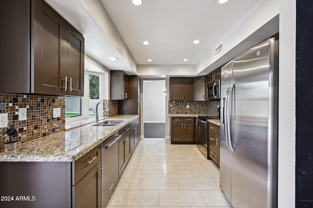 5544 E Paradise Ln, Scottsdale, AZ 85254 - kitchen featuring stainless steel appliances, recessed lighting, tasteful backsplash, light stone counters, and light tile patterned floors