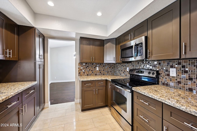 5544 E Paradise Ln, Scottsdale, AZ 85254 - kitchen with stainless steel appliances, tasteful backsplash, light stone counters, and recessed lighting