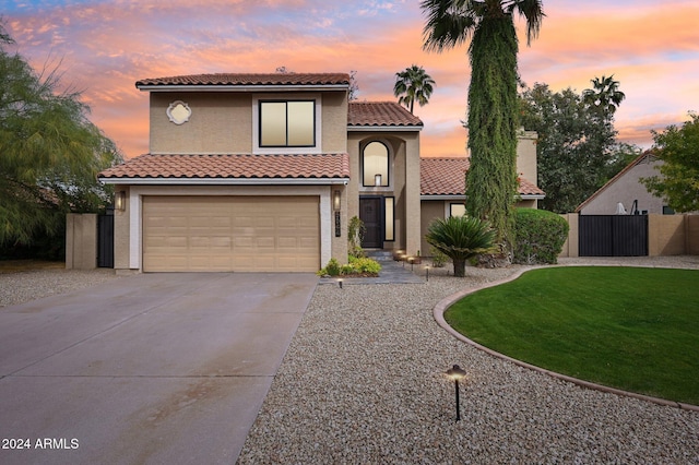 5544 E Paradise Ln, Scottsdale, AZ 85254 - mediterranean / spanish-style house featuring driveway, a garage, a tiled roof, stucco siding, and a gate