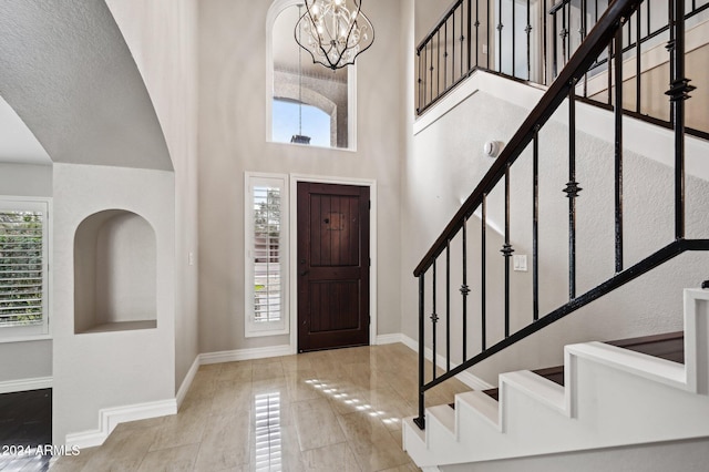 5544 E Paradise Ln, Scottsdale, AZ 85254 - entryway featuring a high ceiling, healthy amount of natural light, a chandelier, and stairs
