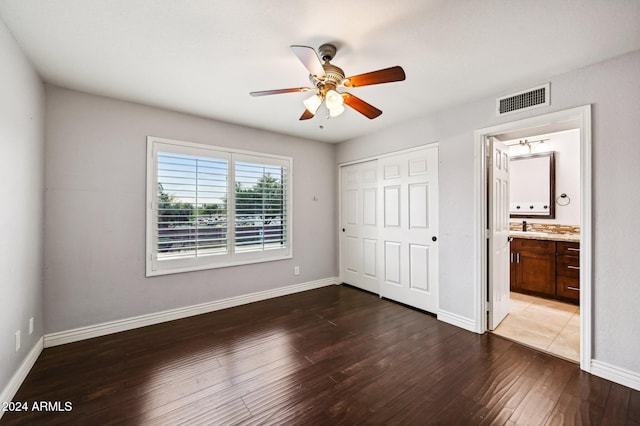 5544 E Paradise Ln, Scottsdale, AZ 85254 - unfurnished bedroom with dark wood-type flooring, a closet, a ceiling fan, and ensuite bathroom
