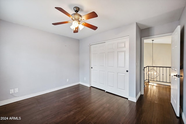 5544 E Paradise Ln, Scottsdale, AZ 85254 - unfurnished bedroom featuring a chandelier, dark wood-style floors, a closet, and a ceiling fan