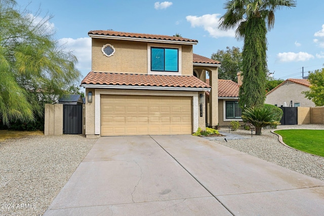 5544 E Paradise Ln, Scottsdale, AZ 85254 - mediterranean / spanish-style home featuring a gate, an attached garage, driveway, stucco siding, and a tiled roof