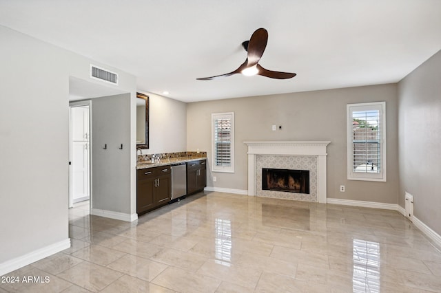5544 E Paradise Ln, Scottsdale, AZ 85254 - unfurnished living room featuring ceiling fan, a tiled fireplace, and light marble finish flooring