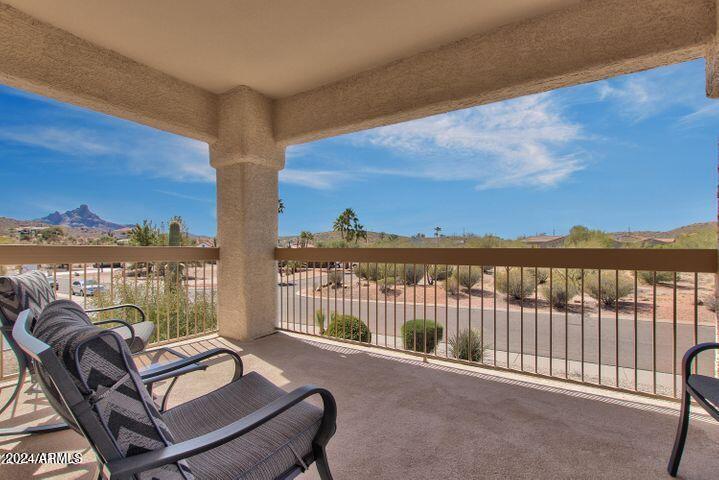 view of patio / terrace with a mountain view and a balcony