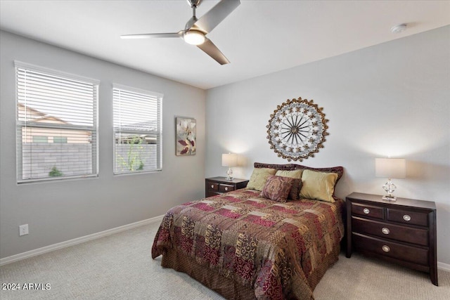 bedroom with light carpet, baseboards, and ceiling fan