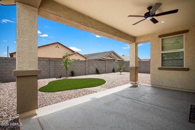 view of patio with a fenced backyard and a ceiling fan