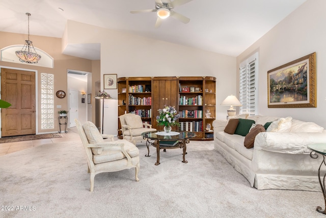 living room with ceiling fan, high vaulted ceiling, and light colored carpet