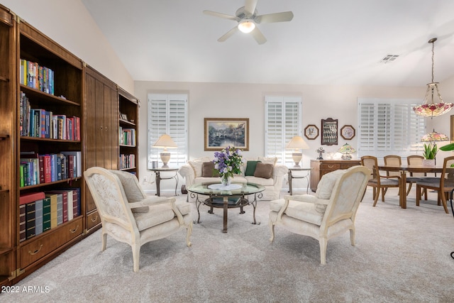 carpeted living room with vaulted ceiling and ceiling fan