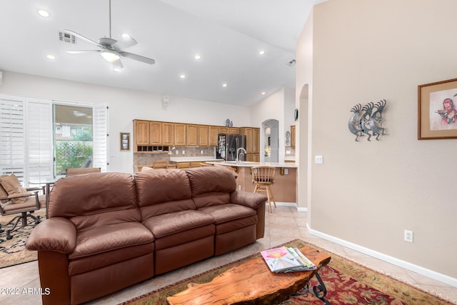 living room with high vaulted ceiling, ceiling fan, and light tile patterned floors