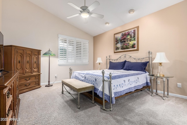 carpeted bedroom with ceiling fan and vaulted ceiling