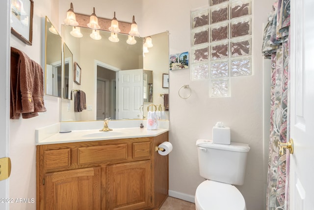 bathroom featuring toilet and vanity