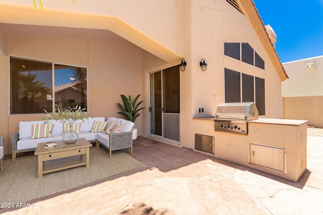 view of patio with an outdoor hangout area, area for grilling, and an outdoor kitchen