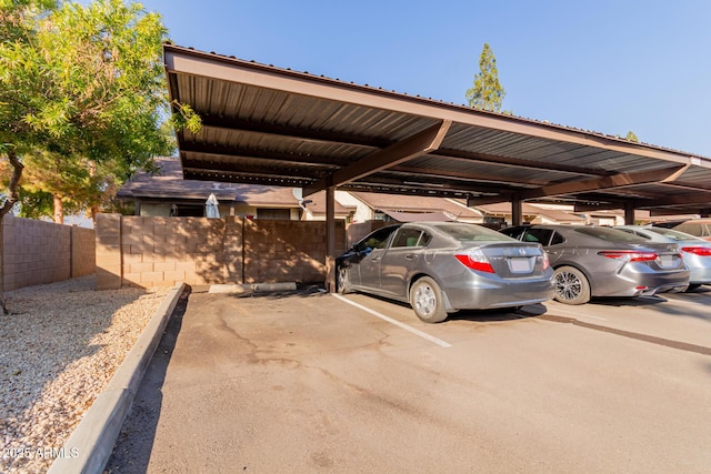 view of parking / parking lot featuring a carport