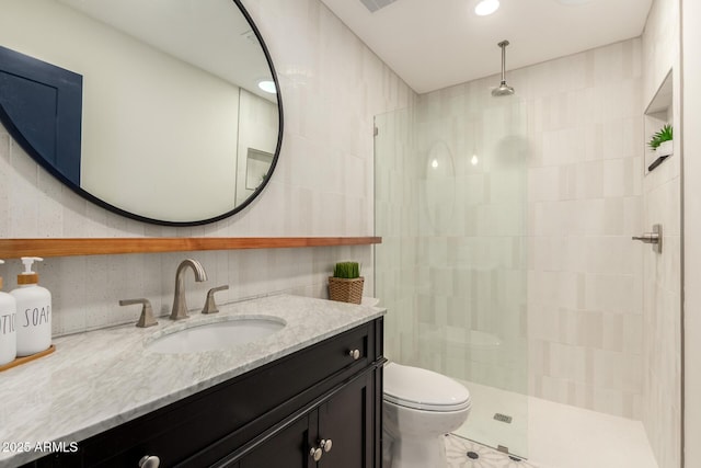 5612 N 9th St, Phoenix, AZ 85014 - bathroom featuring walk in shower, vanity, toilet, tile patterned flooring, and tile walls