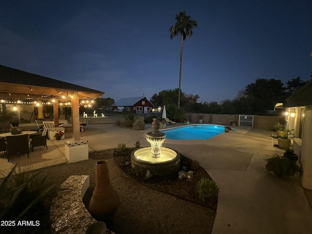 pool at night with a patio