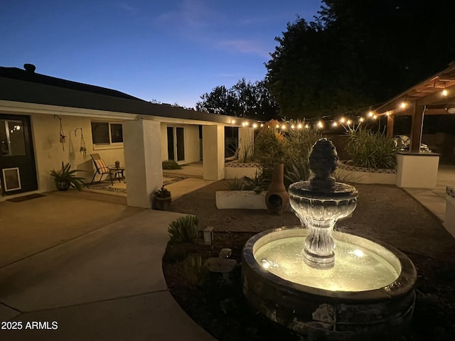 view of patio terrace at dusk