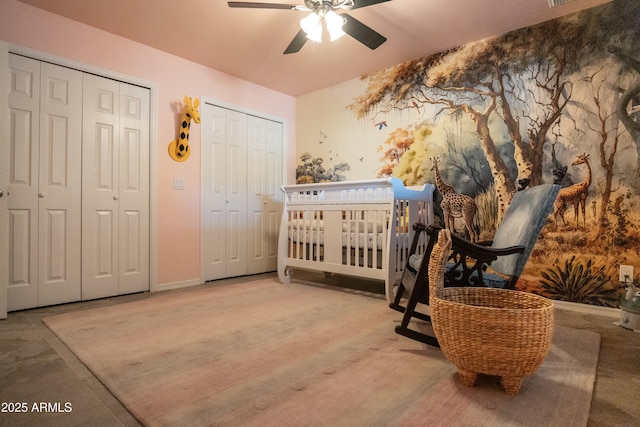 bedroom featuring two closets and ceiling fan