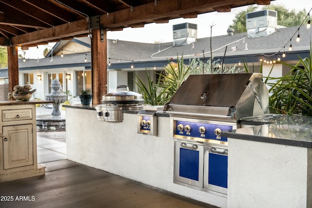 view of patio with area for grilling and an outdoor kitchen