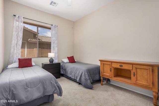 bedroom with visible vents and light carpet