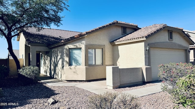 1630 W Pecan Rd, Phoenix, AZ 85041 - view of side of home featuring an attached garage, stucco siding, and a tile roof