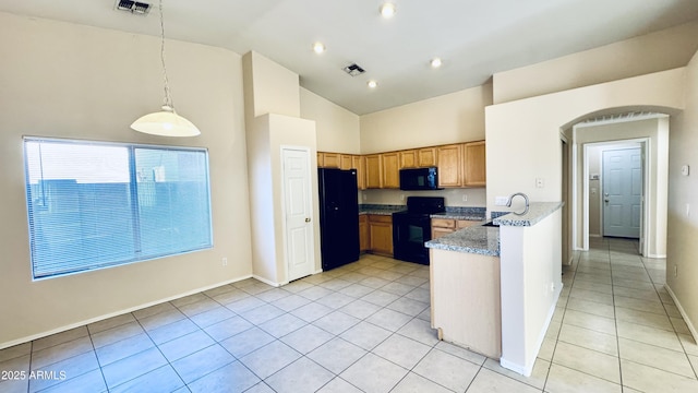 1630 W Pecan Rd, Phoenix, AZ 85041 - kitchen with black appliances, light tile patterned flooring, decorative light fixtures, light stone counters, and high vaulted ceiling