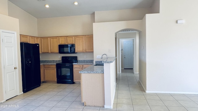 1630 W Pecan Rd, Phoenix, AZ 85041 - kitchen featuring black appliances, light tile patterned floors, arched walkways, a peninsula, and light stone counters