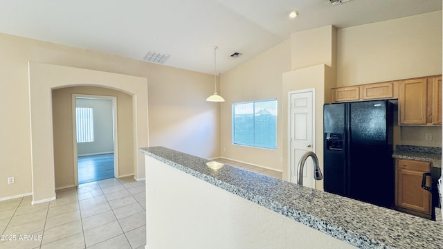1630 W Pecan Rd, Phoenix, AZ 85041 - kitchen with black fridge with ice dispenser, arched walkways, light tile patterned floors, healthy amount of natural light, and high vaulted ceiling