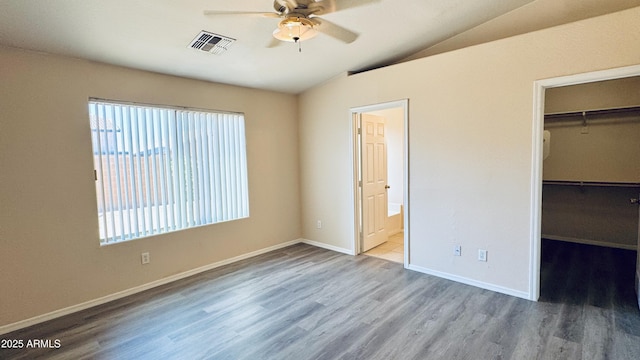 1630 W Pecan Rd, Phoenix, AZ 85041 - unfurnished bedroom featuring wood finished floors, vaulted ceiling, a walk in closet, a closet, and ensuite bathroom