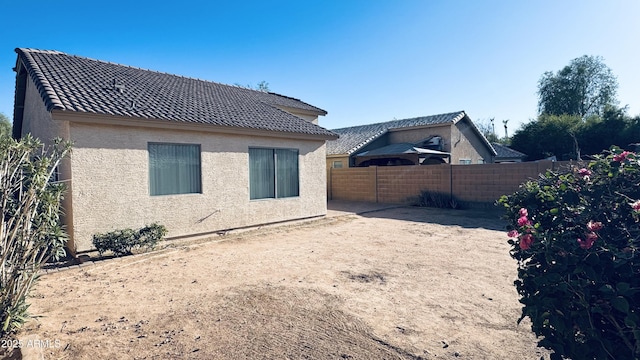 1630 W Pecan Rd, Phoenix, AZ 85041 - rear view of house featuring stucco siding, a fenced backyard, and a tile roof
