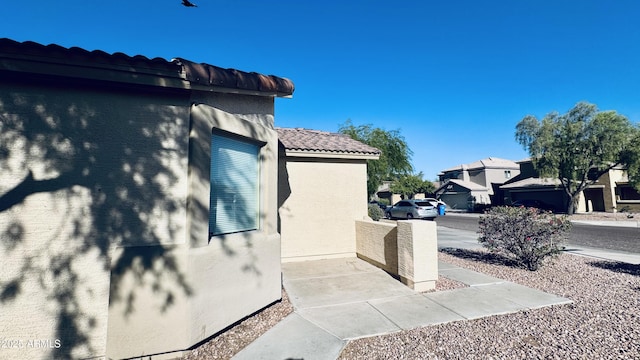 1630 W Pecan Rd, Phoenix, AZ 85041 - view of home's exterior with stucco siding, a tile roof, and a residential view