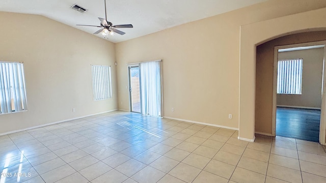 1630 W Pecan Rd, Phoenix, AZ 85041 - empty room with light tile patterned floors, ceiling fan, lofted ceiling, and arched walkways