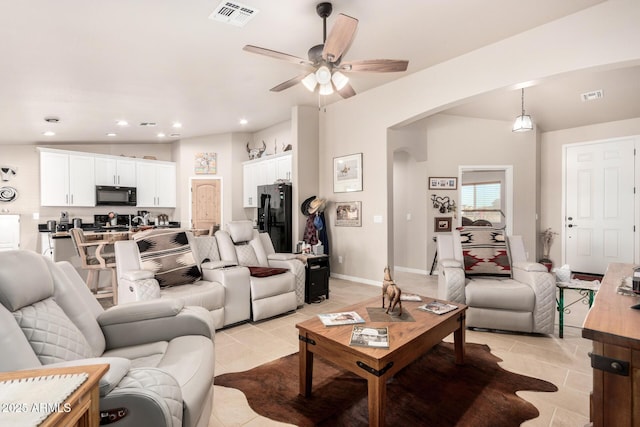 tiled living room featuring ceiling fan