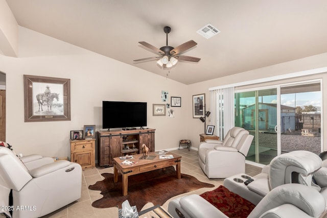 living room featuring vaulted ceiling, light tile patterned floors, and ceiling fan