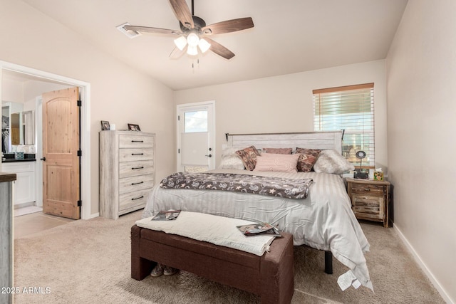 bedroom with ceiling fan, lofted ceiling, light carpet, and ensuite bath