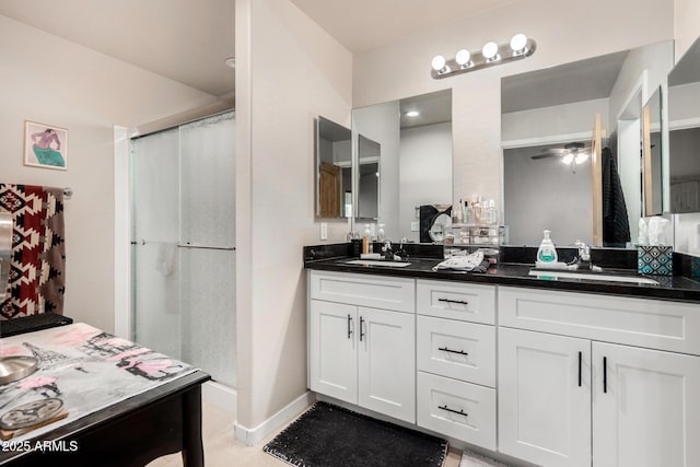 bathroom with vanity, ceiling fan, and walk in shower