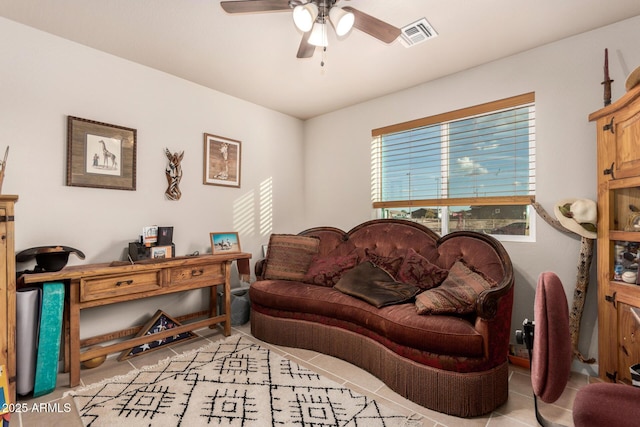 living room featuring light tile patterned flooring and ceiling fan