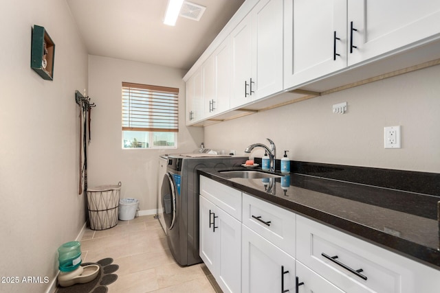 washroom featuring cabinets, separate washer and dryer, sink, and light tile patterned floors